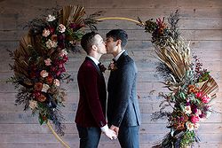 Rustic Same Sex Wedding Fondata 1872 Gay Ceremony Inside circular arbor first kiss